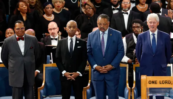 Bill Clinton sits with Nation of Islam leader Louis Farrakhan at Aretha Franklin funeral