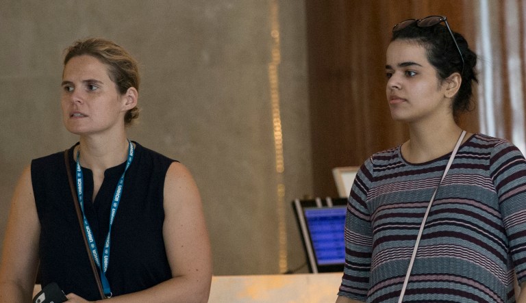 Rahaf Mohammed Alqunun, right, walks with an unidentified companion in Bangkok, Thailand, on Friday.