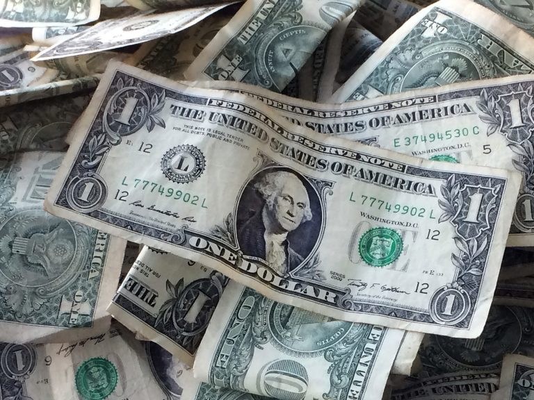 FILE - This Oct. 24, 2016, file photo shows dollar bills in New York. (AP Photo/Mark Lennihan, File)