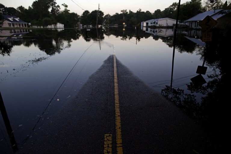 FILE - In this Aug. 20, 2016, file photo, standing floodwater closes roads in Sorrento, La. (AP Photo/Max Becherer, File)
