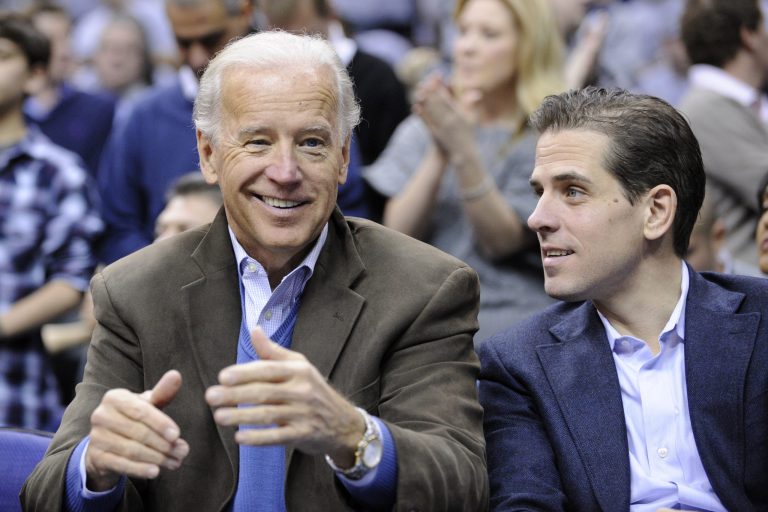 In this Jan. 30, 2010, file photo, Vice President Joe Biden, left, with his son Hunter, right, at the Duke Georgetown NCAA college basketball game in Washington. 