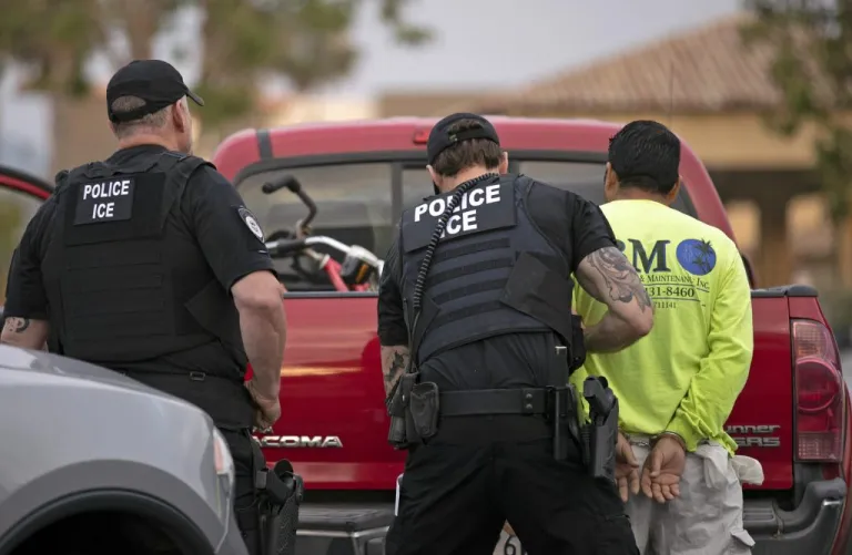  In this July 8, 2019 file photo, U.S. Immigration and Customs Enforcement (ICE) officers detain a man during an operation in Escondido, Calif. The Biden ICE has stopped issuing Twitter alerts about fugitive illegal immigrants in communities.