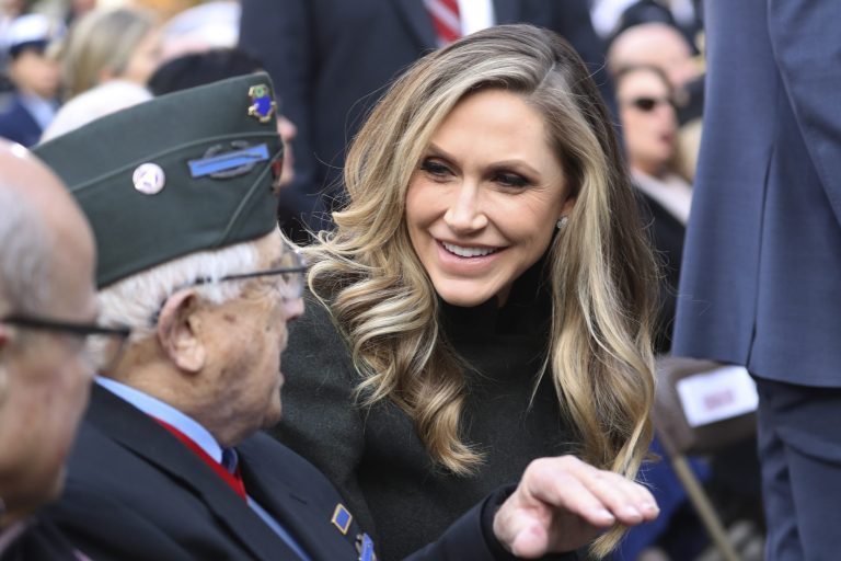 Lara Trump talks to guests at the New York City Veterans Day Parade at Madison Square Park in New York, Monday, Nov. 11, 2019. She has long been an animal rights activist and is eager to end the live animal markets in China.