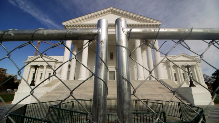 The Virginia state Capitol building is surrounded by fencing, Thursday, Jan. 16, 2020 in Richmond, Va., in preparation for Monday's rally by gun rights advocates.