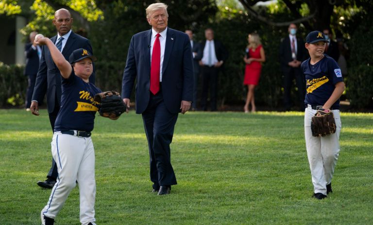 President Donald Trump walks with former New York Yankees Hall of Fame pitcher Mariano Rivera as he greets youth baseball players on the South Lawn of the White House to mark Opening Day for Major League Baseball, Thursday, July 23, 2020, in Washington.