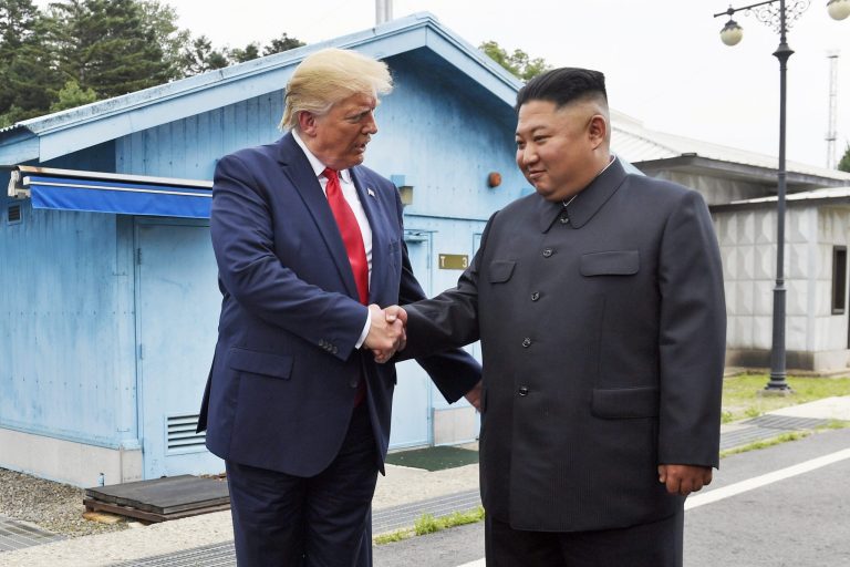 In this June 30, 2019, file photo, President Donald Trump shakes hands with North Korean leader Kim Jong Un at the border village of Panmunjom in the Demilitarized Zone, South Korea. A new survey finds more believe Trump is a threat to world peace.