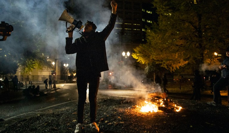 A Black Lives Matter protester chants slogans on Wednesday early morning, Nov. 4, 2020, in Portland, Oregon. 