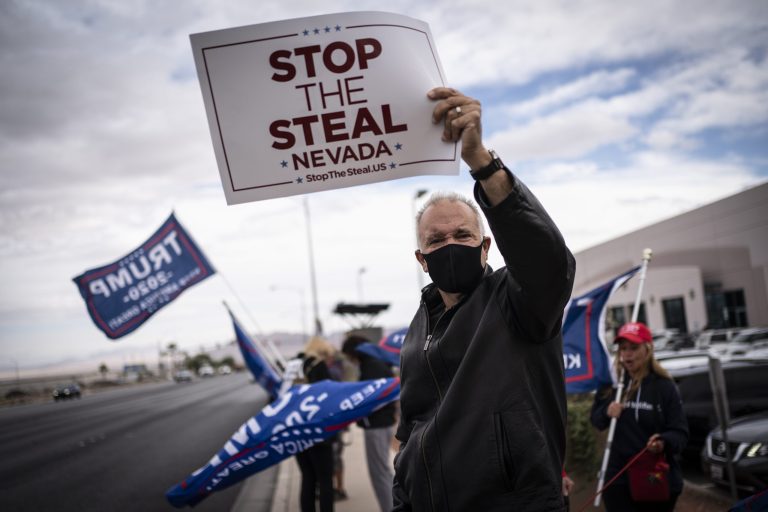 Supporters of President Donald Trump hold signs as they stand outside of the Clark County Elections Department in North Las Vegas, Nev. Saturday, Nov. 7, 2020. A new Rasmussen Reports survey said 75% of Republicans feel the election was stole from Trump.