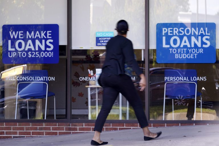 A woman walks past a personal finance loan office in Franklin, Tenn. just before the election.