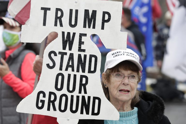 A supporter of President Donald Trump attends a rally at Freedom Plaza, Saturday, Dec. 12, 2020, in Washington. Polls show majorities of Republicans believe the presidential election was fraudulent.
