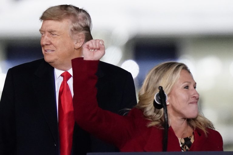 Rep. Marjorie Taylor Greene, R-Ga., speaks as President Donald Trump listens at a campaign rally in support of losing Senate candidates Sen. Kelly Loeffler, R-Ga., and David Perdue in Dalton, Ga., Monday, Jan. 4, 2021.
