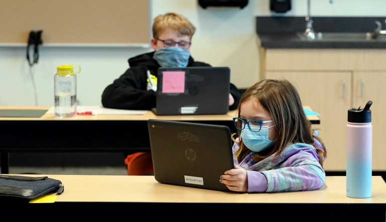 In this Feb. 2, 2021 file photo, students wear masks as they work in a fourth-grade classroom, at Elk Ridge Elementary School in Buckley, Wash. After seeing two academic years thrown off course by the pandemic, school leaders around the country are planning for the possibility of more distance learning next fall at the start of yet another school year.