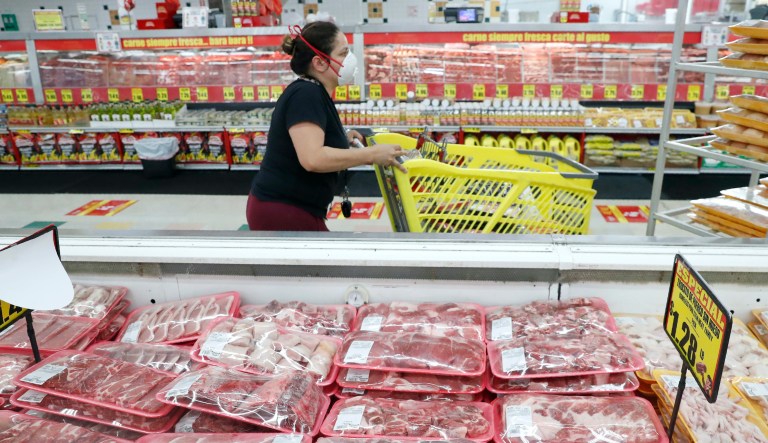 In this April 29, 2020 file photo, a shopper wears a mask as she walks through the meat products at a grocery store in Dallas, Wednesday. Wholesale prices, boosted by rising food costs, increased 0.8% in May 2021, and are up by a record amount over the past year, another indication that inflation pressures are rising since the economy has begun to re-open following the pandemic lockdowns.