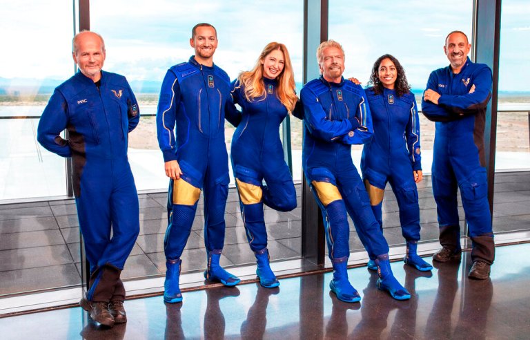This image provided by Virgin Galactic shows, from left: Chief Pilot Dave Mackay, Lead Operations Engineer Colin Bennett,  Chief Astronaut Instructor Beth Moses, Founder of Virgin Galactic Richard Branson, Vice President of Government Affairs and Research Operations Sirisha Bandla and pilot Michael Masucci. (Virgin Galactic via AP)