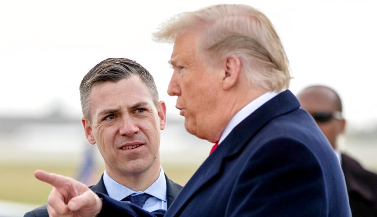 President Donald Trump is greeted by Rep. Trey Hollingsworth (R-IN), left, and Rep. Jim Banks (R-IN), second from right, as he arrives at Indianapolis International Airport in Indianapolis, Saturday, Oct. 27, 2018, to speak at the 91st Annual Future Farmers of America Convention and Expo. 