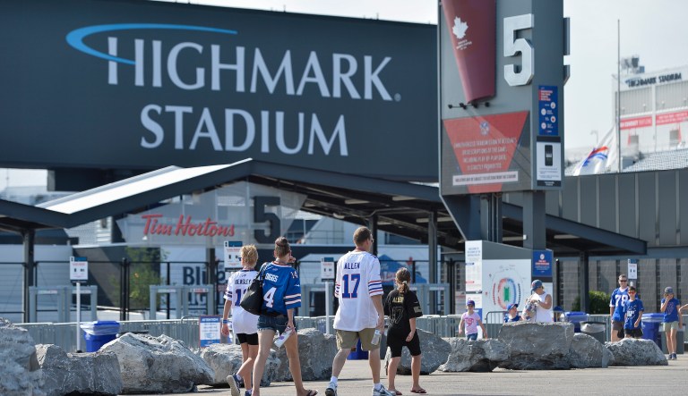 Fans walk outside Highmark Stadium before a preseason NFL football game between the Buffalo Bills and the Green Bay Packers in Orchard Park, N.Y., Saturday, Aug. 28, 2021. 