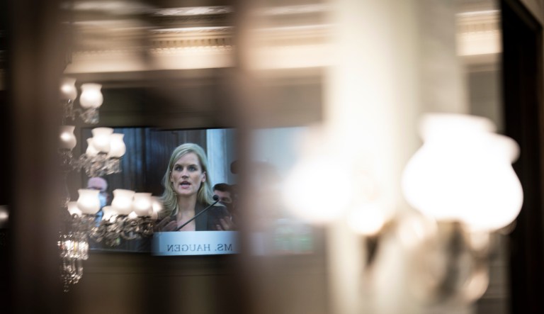 Former Facebook data scientist Frances Haugen is reflected in a screen as she speaks during a hearing of the Senate Commerce, Science, and Transportation Subcommittee on Consumer Protection, Product Safety, and Data Security, on Capitol Hill, Tuesday, Oct. 5, 2021, in Washington.