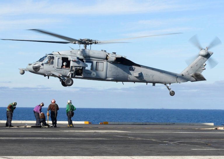 FILE - In this March 19, 2017, file photo, released by the U.S. Navy, an MH-60S Sea Hawk helicopter prepares to land on the flight deck of the aircraft carrier USS Nimitz in the Pacific Ocean. The remains of five people and the wreckage of a U.S. Navy helicopter that crashed in the Pacific Ocean off California have been recovered, the Navy said in a statement Tuesday, Oct. 12, 2021. An MH-60S helicopter, similar to the one pictured, its two pilots and three other sailors were lost in an Aug. 31 accident about 69 miles (111 kilometers) off the San Diego coast. 