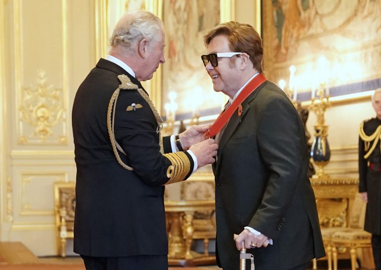 Sir Elton John is made a member of the Order of the Companions of Honour by Prince Charles during an investiture ceremony at Windsor Castle, in Windsor, England, Wednesday, Nov. 10, 2021.