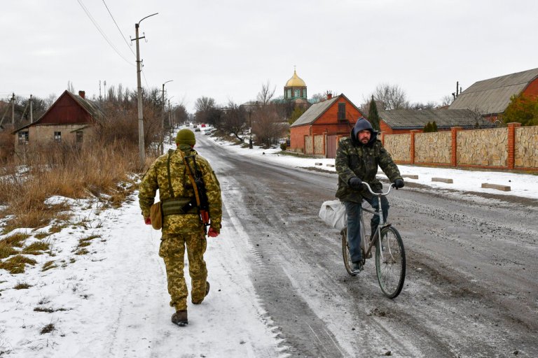 A Ukrainian serviceman patrols a street near the frontline with Russia-backed separatists in Verkhnotoretske village in Yasynuvata district, Donetsk region, eastern Ukraine, Jan. 22, 2022.  (AP Photo/Andriy Andriyenko, File)
