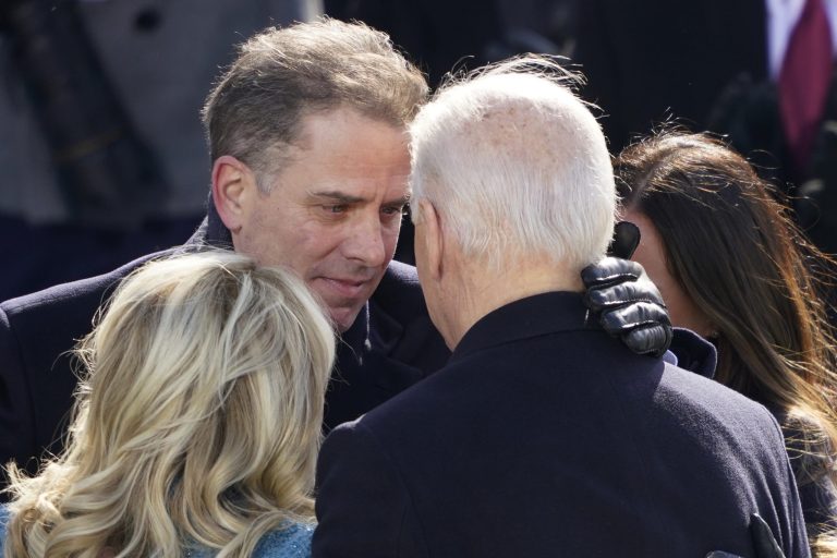 President Joe Biden hugs first lady Jill Biden, his son Hunter Biden, and daughter Ashley Biden.