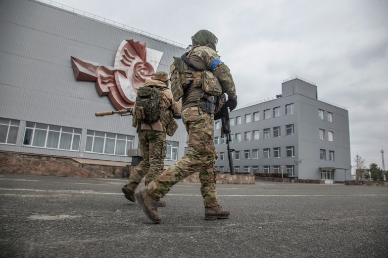 Ukrainian servicemen walk at the Chernobyl nuclear plant, in Chernobyl, Ukraine, Tuesday, April 5, 2022.