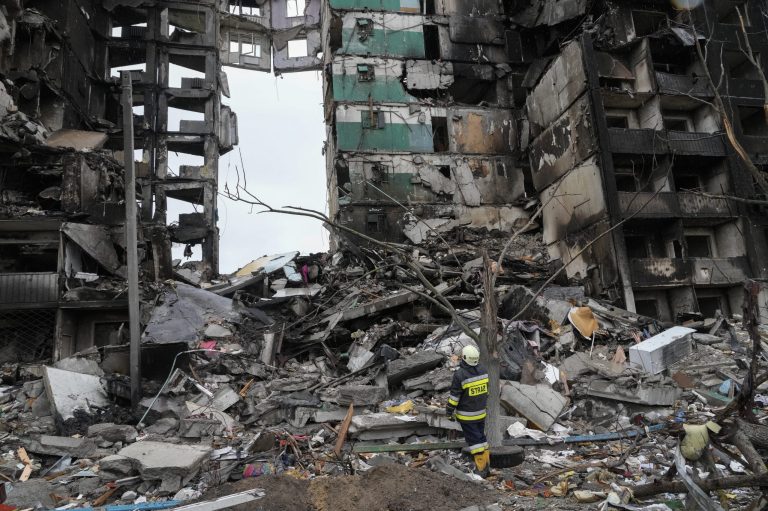 An emergency worker on Saturday stands by a multistory building destroyed in a Russian air raid in Borodyanka, Ukraine.