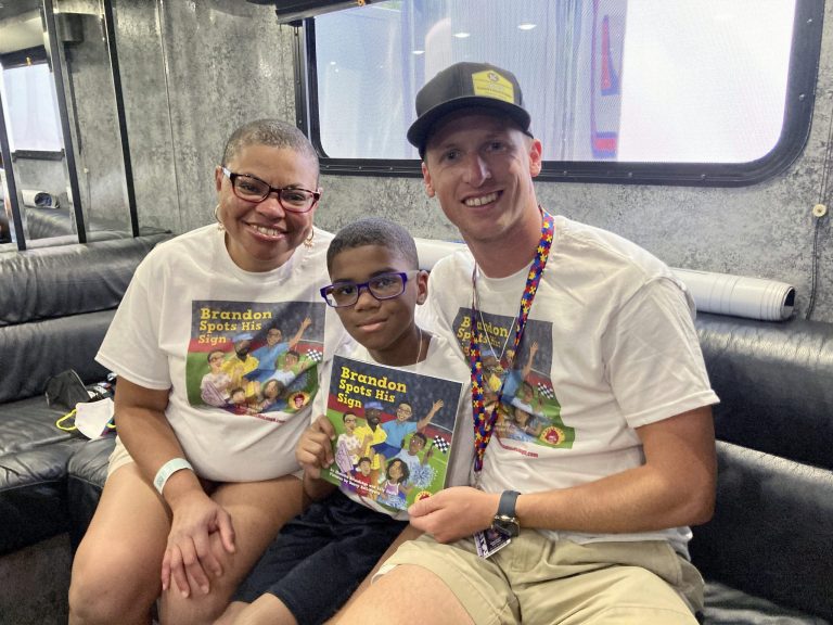 Sheletta Brundidge, left, her son Brandon, center, and NASCAR driver Brandon Brown met Saturday, July 2, 2022 at Road America in Elkhart Lake, Wisconsin. Sheletta Brundidge was inspired to write a childrenâs book about the positive impact that âLetâs go, Brandonâ signs had on her son. 
