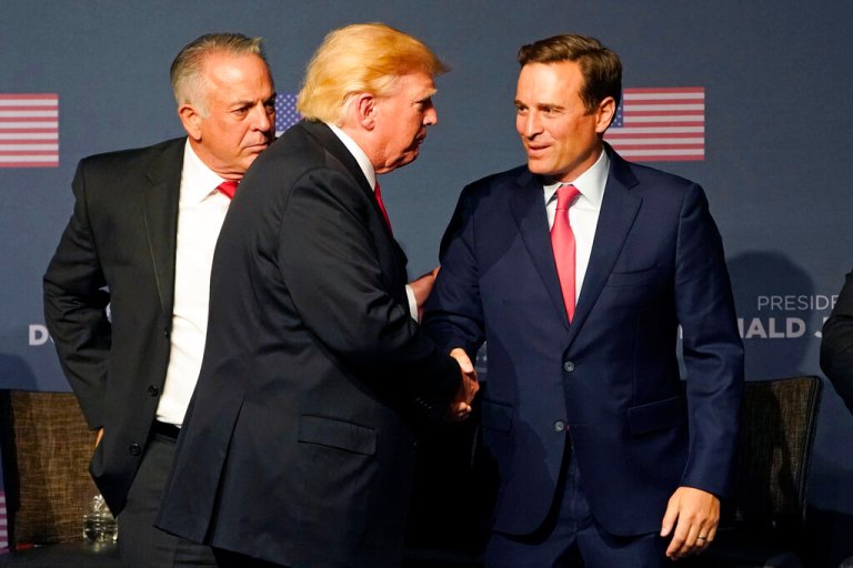 Former President Donald Trump, center, shakes hands with Republican Nevada Senate candidate Adam Laxalt, right, and Joe Lombardo, Clark County sheriff and Republican candidate for Nevada governor, left, during an event Friday, July 8, 2022, in Las Vegas. 