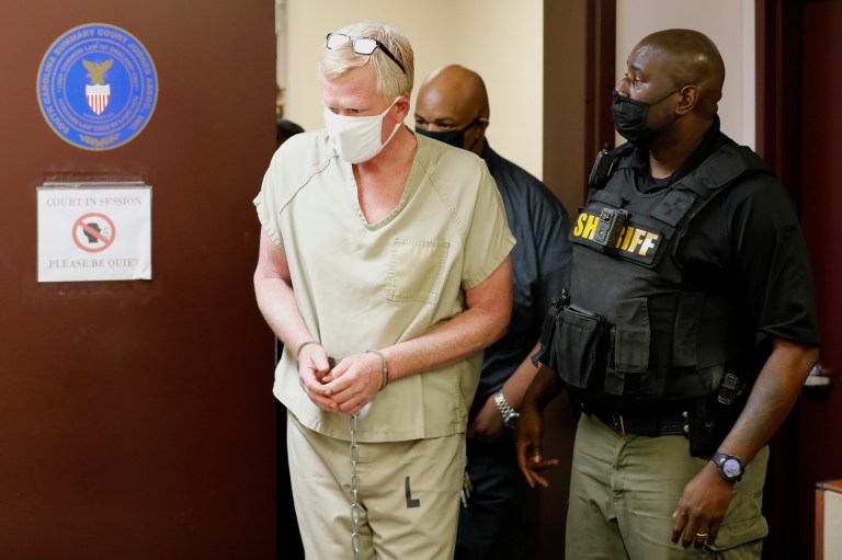 Disgraced South Carolina attorney Alex Murdaugh, left, walks into court for his bond hearing on Sept. 16, 2021, in Varnville, South Carolina. Murdaugh was charged Thursday, July 14, 2022, with murder in connection with the mysterious 2021 deaths of his wife and son. 