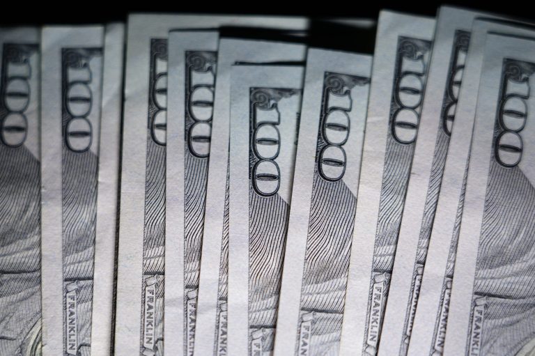 U.S. $100 bills are seen, Thursday, July 14, 2022, in Marple Township, Pennsylvania. (AP Photo/Matt Slocum)
