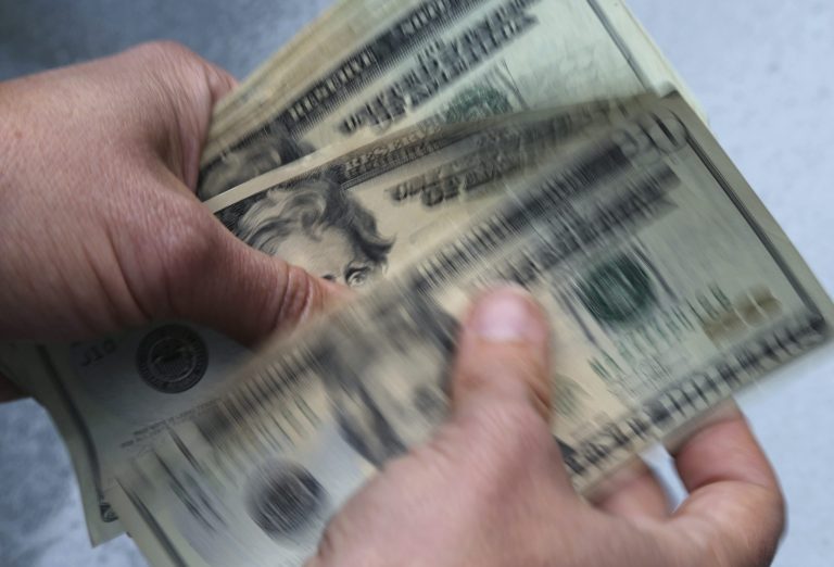 FILE - Twenty dollar bills are counted in North Andover, Mass., on June 15, 2018. Anyone living in Connecticut who claimed at least one dependent child on their 2021 federal income tax return might have been eligible, according to the governorâs office. (AP Photo/Elise Amendola, File)
