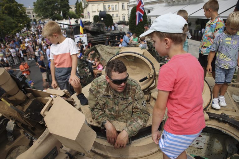 People attend a military picnic marking the Polish Army Day in Warsaw, Poland, Monday, Aug. 15, 2022. The Polish president and other officials marked their nation's Armed Forces Day holiday Monday alongside the U.S. Army commander in Europe and regular American troops. 