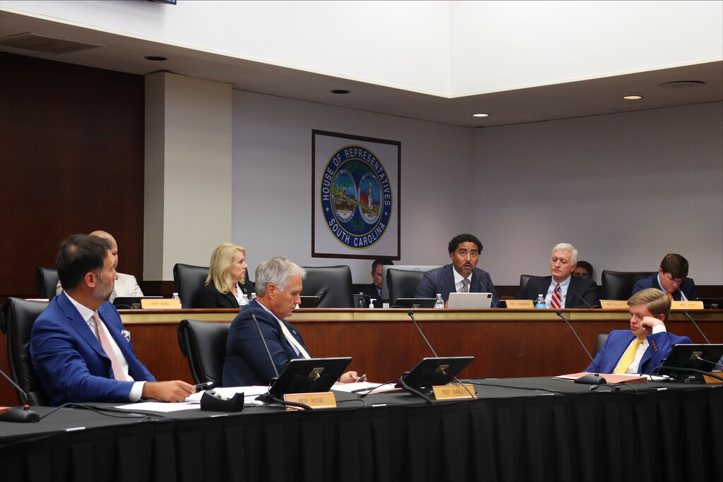 Lawmakers on the South Carolina House Judiciary Committee listen as Rep. Justin Bamberg details his opposition to a proposed abortion ban on Tuesday in Columbia, South Carolina.