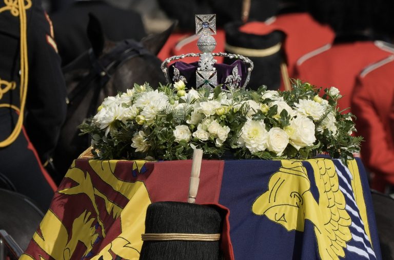 The coffin of Queen Elizabeth II, left, leaves Buckingham Palace for Westminster Hall in London on Sept. 14, 2022.