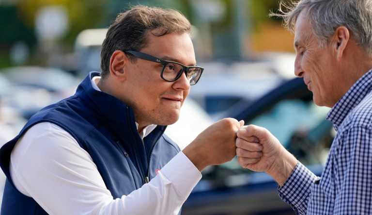 Republican candidate for New York's 3rd Congressional District George Santos, left, fist bumps campaign volunteer John Maccarone, of Glen Cove, N.Y., while campaigning outside a Stop and Shop store, Saturday, Nov. 5, 2022, in Glen Cove, N.Y.