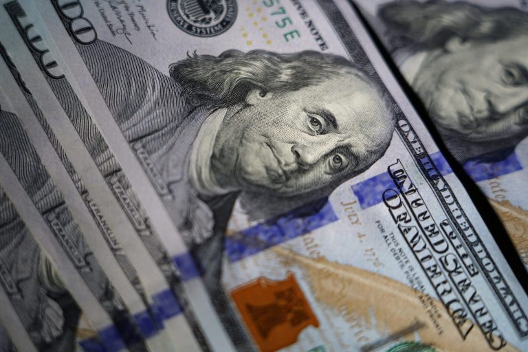 FILE - The likeness of Benjamin Franklin is seen on U.S. $100 bills, Thursday, July 14, 2022, in Marple Township, Pennsylvania. (AP Photo/Matt Slocum)