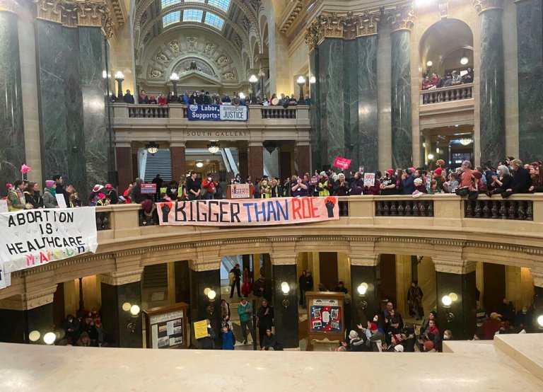 Abortion rights supporters display banners as they gather in the Wisconsin state Capitol in Madison, Wis., on Sunday, Jan. 22, 2023. 