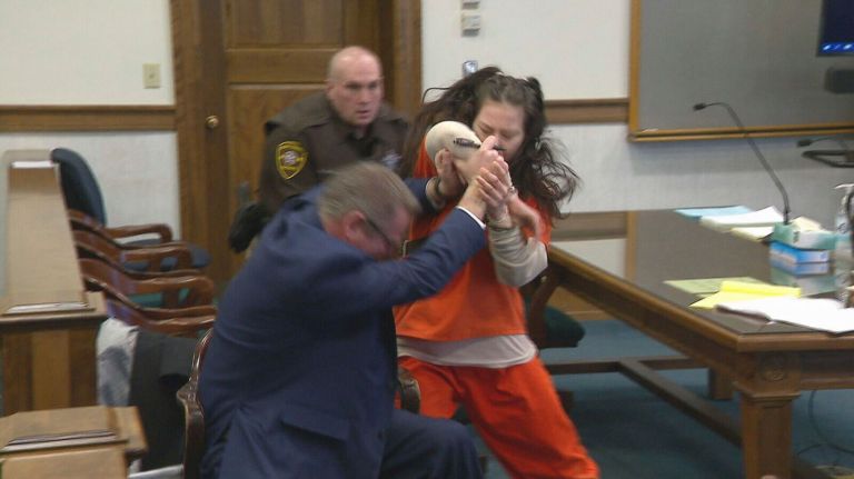 WATCH: Woman accused of dismembering murder victim attacks lawyer in court