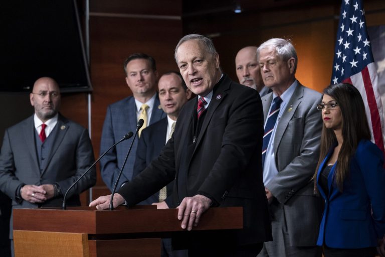 Rep. Andy Biggs, R-Ariz., center, speaks as members of the House Freedom Caucus hold a news conference at the Capitol in Washington, Friday, March 10, 2023. From left are Rep. Clay Higgins, R-La., Rep. Michael Cloud, R-Fla., Rep. Bob Good, R-Va., Rep. Andy Biggs, R-Ariz., Rep. Chip Roy, R-Texas, Rep. Ralph Norman, R-S.C., and Rep. Lauren Boebert, R-Colo. 