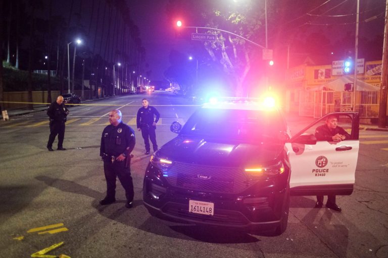 FILE - Police officers stand guard near a crime scene where three Los Angeles police officers were shot, Wednesday, March 8, 2023, in Los Angeles. (AP Photo/Ringo H.W. Chiu,File)
