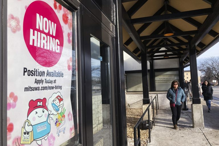 A hiring sign is displayed at a grocery store in Arlington Heights, Illinois, Tuesday, Dec. 27, 2022. 