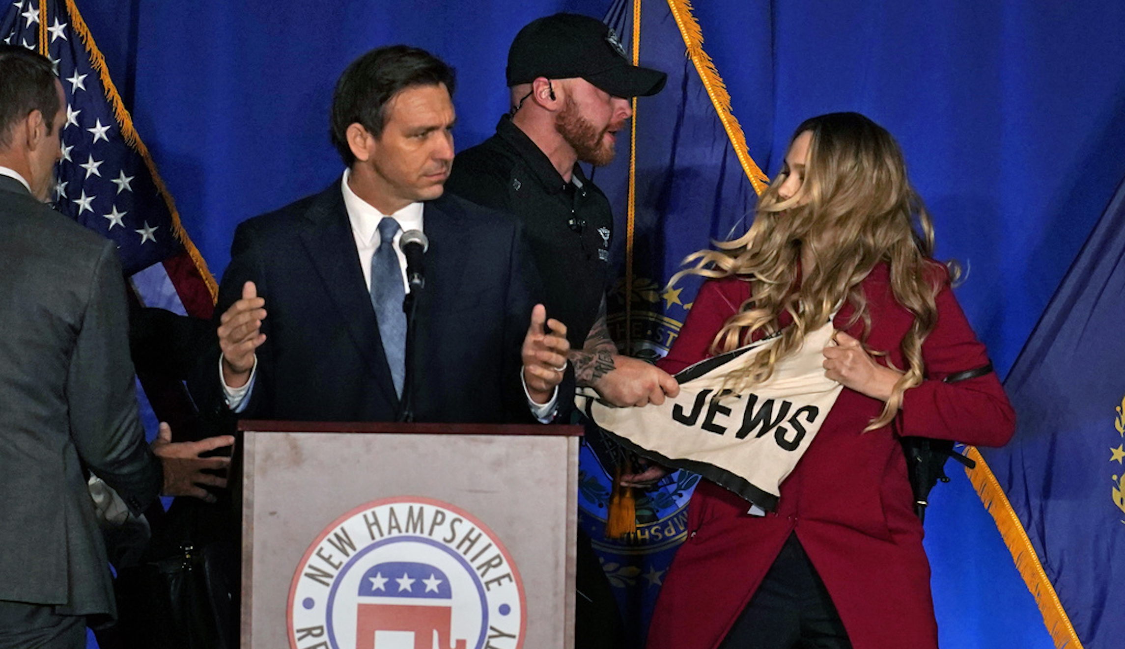 Protesters storm stage during DeSantis speech in New Hampshire