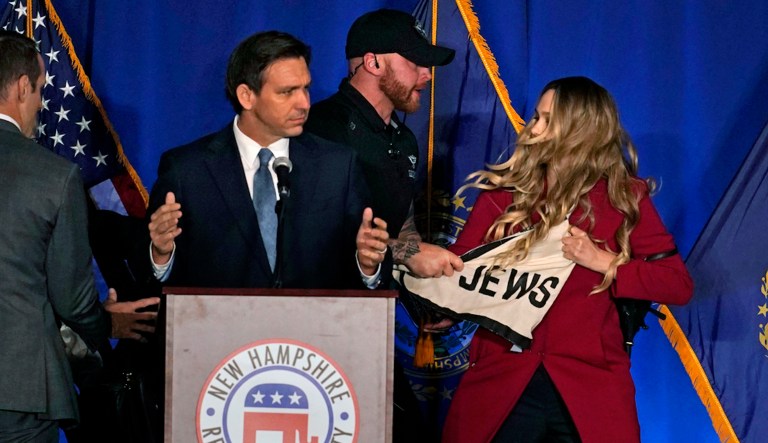 Protesters storm stage during DeSantis speech in New Hampshire