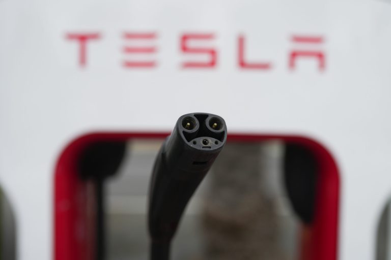 Tesla's EV charging connector is pictured at a charging station in Anaheim, Calif., Friday, June 9, 2023. Owners of General Motors and Ford electric vehicles will be able charge at many of Tesla's large network of stations across the U.S. starting next year. 