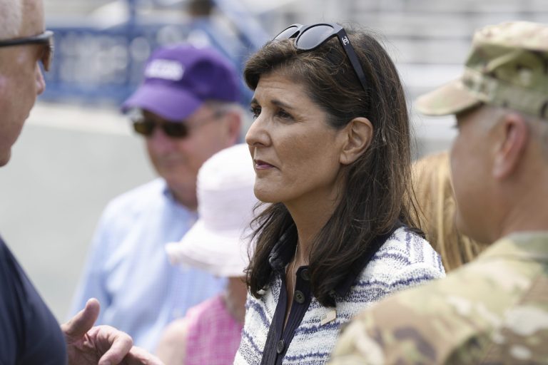 Republican presidential candidate Nikki Haley, center, stands with her husband, Maj. Michael Haley, talking with other military families following a deployment ceremony for his South Carolina National Guard unit on Saturday, June 17, 2023, in Charleston, S.C. Haley's yearlong deployment to Africa will encompass much of the campaign of his wife, former Gov. Nikki Haley, for the 2024 GOP presidential nomination. 