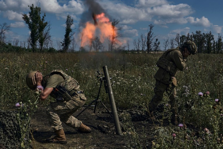 Ukrainian soldiers fire a mortar toward Russian positions at the front line, near Bakhmut, Donetsk region, Ukraine, on Aug. 12, 2023. 