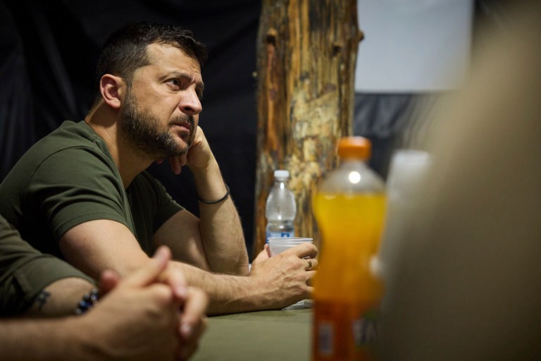 In this photo provided by the Ukrainian Presidential Press Office, Ukrainian President Volodymyr Zelenskyy listens to servicemen during his visit to the headquarters of brigades at the front line near Soledar, Donetsk region, Ukraine, Monday, Aug. 14, 2023.