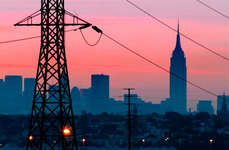 The Empire State Building towers over the skyline of a blackout-darkened New York City just before dawn of Aug. 15, 2003. Years after a blackout cascading from Ohio affected 50 million people, utilities and analysts say changes made in the aftermath make a similar outage unlikely today, though shifts in where and how power is generated raise new reliability concerns for the U.S. electric grid system.