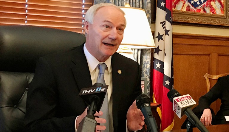 Arkansas Gov. Asa Hutchinson speaks to reporters at the state Capitol in Little Rock, Ark., on Thursday, Jan. 4, 2018, about a drop in the number of people enrolled in the state's Medicaid program. 